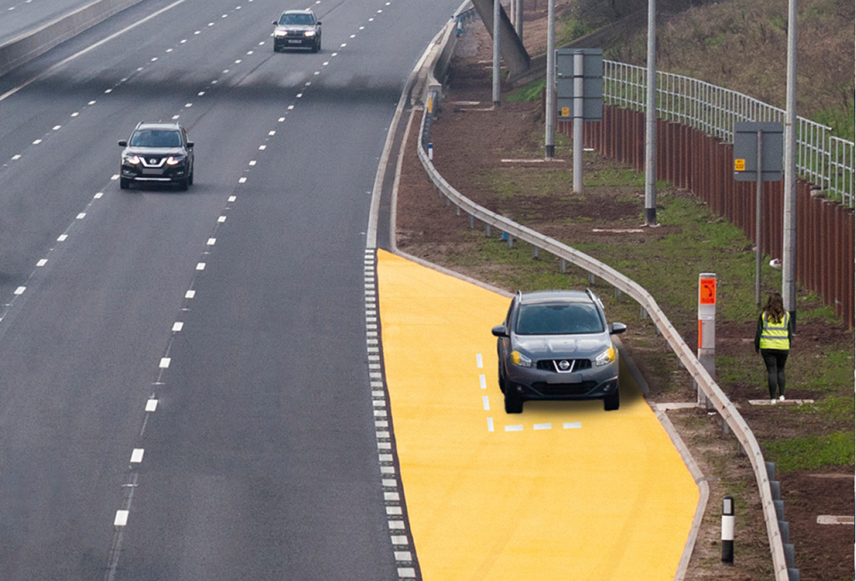 Photograph of a motorway emergency area marked with orange surfacing on the left, with a car parked safely off the running lanes